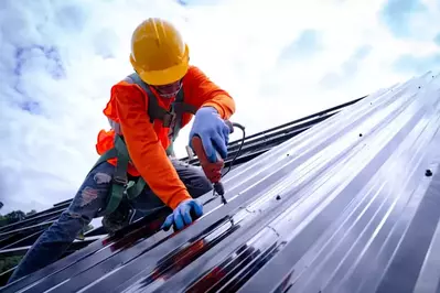 worker on metal roof